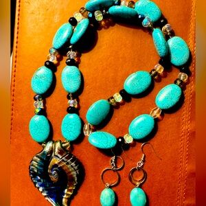Handmade turquoise necklace with glass pendant and matching earrings.